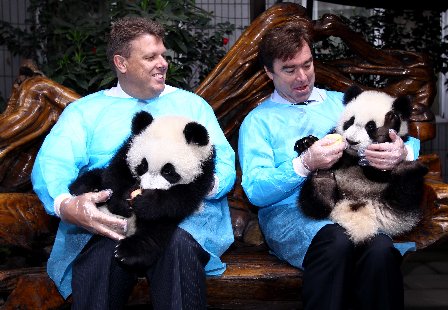 Doug Jackson (R), president of Coca Cola Greater China and South Korea, holds Mei Mei in his arms. Doug Jackson (R), president of Coca Cola Greater China and South Korea, holds Mei Mei in his arms.
