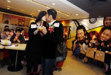 Model Kelvin Kwong and nurse Ashley Tse kiss in front of their friends and relatives during a surprise engagement bash thrown by Kelvin during Valentine's Day inside a McDonald's restaurant in Hong Kong, February 14, 2011. Model Kelvin Kwong and nurse Ashley Tse kiss in front of their friends and relatives during a surprise engagement bash thrown by Kelvin during Valentine's Day inside a McDonald's restaurant in Hong Kong, February 14, 2011.