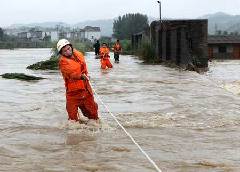Rescue workers attempt to save people stranded by floods in Wuning county, East China's Jiangxi Province on Monday. Rescue workers attempt to save people stranded by floods in Wuning county, East China's Jiangxi Province on Monday.