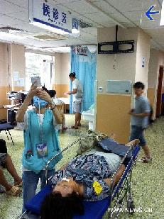 A wounded woman receives medical treatment at the Peking University People's Hospital after an accident happened in the Beijing Zoo Station of Subway Line 4 in downtown Beijing, capital of China, July 5, 2011. A wounded woman receives medical treatment at the Peking University People's Hospital after an accident happened in the Beijing Zoo Station of Subway Line 4 in downtown Beijing, capital of China, July 5, 2011.