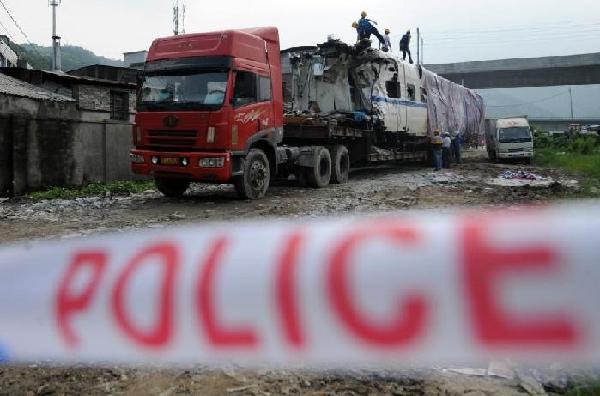 An excavator is used to dismantle a carriage of a derailed train from Saturday's devastating rail crash near the city of Wenzhou in East China's Zhejiang province. An excavator is used to dismantle a carriage of a derailed train from Saturday's devastating rail crash near the city of Wenzhou in East China's Zhejiang province.